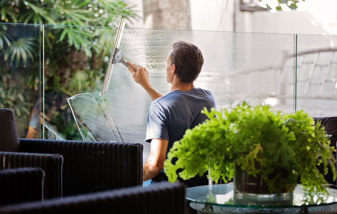 Professional squeegeeing soap from large glass panels